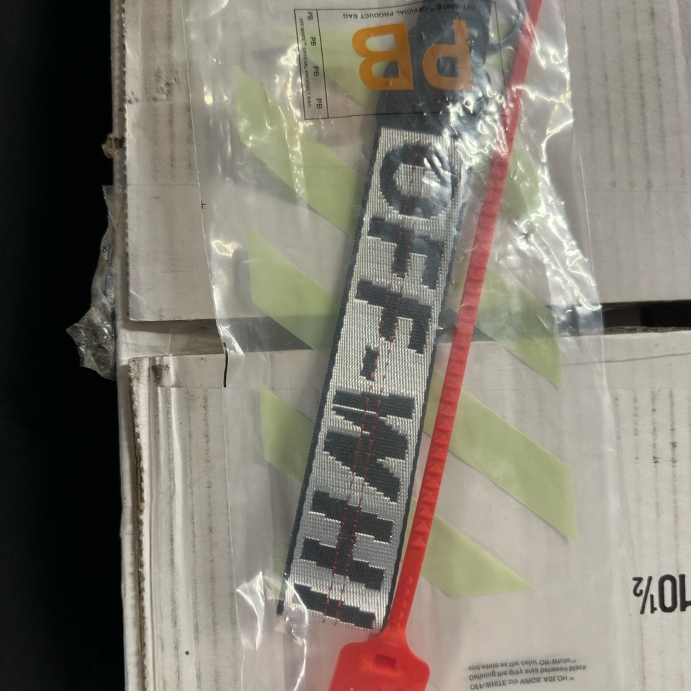 Off-White Keychain with Red and Black Accents